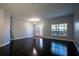 An airy living room featuring new flooring, a large window, and a glass paneled front door at 535 Belle Fern Ct, Ocoee, FL 34761