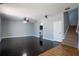 Open-concept living room featuring hardwood floors, a ceiling fan, and easy access to the staircase at 535 Belle Fern Ct, Ocoee, FL 34761