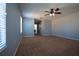 Bright and airy main bedroom boasting a ceiling fan, neutral carpet, and an adjacent hallway at 535 Belle Fern Ct, Ocoee, FL 34761