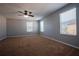 Large bedroom featuring neutral carpet, a ceiling fan, and natural light from three windows at 535 Belle Fern Ct, Ocoee, FL 34761
