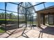 Screened-in porch features brick pavers, providing a view to the backyard with a basketball hoop at 535 Belle Fern Ct, Ocoee, FL 34761