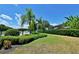 Lush backyard featuring tropical landscaping, a black metal fence, and a glimpse of the pool at 535 Belle Fern Ct, Ocoee, FL 34761