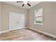 Bedroom with laminate flooring, a ceiling fan, and a window for natural light at 5532 Black Hawk Ln, Lakeland, FL 33810