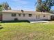 Spacious backyard with well-maintained lawn and a concrete patio, ideal for outdoor gatherings at 5825 Hafer Ln, Orlando, FL 32808