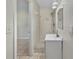 Bathroom featuring a tiled shower stall, vanity, and mirror with open doorway to bedroom at 5825 Hafer Ln, Orlando, FL 32808