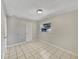 Bright bedroom featuring neutral walls, tiled floor, and window letting in natural light at 5825 Hafer Ln, Orlando, FL 32808