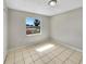 Bedroom with ceramic tile floors and large window with natural light at 5825 Hafer Ln, Orlando, FL 32808