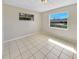 Bedroom featuring ceramic tile floors and natural lighting from dual windows at 5825 Hafer Ln, Orlando, FL 32808