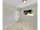 Cozy bedroom featuring ceramic tile floors, a closet, and natural light at 5825 Hafer Ln, Orlando, FL 32808