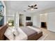 Comfortable bedroom with a ceiling fan, TV, dresser, and a view into the bathroom and closet at 5825 Hafer Ln, Orlando, FL 32808