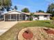 Charming single-story home with a screened-in porch, well-manicured lawn, and stone accents at 5825 Hafer Ln, Orlando, FL 32808