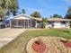 Charming single-story home with a screened-in porch, well-manicured lawn, and stone accents at 5825 Hafer Ln, Orlando, FL 32808