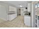 Bright kitchen with white cabinets, granite counters, and ceramic tile flooring at 5825 Hafer Ln, Orlando, FL 32808