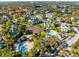 A picturesque aerial of the community featuring a pool, tennis courts, and lush greenery near a serene lake at 6178 Westgate Dr # 304, Orlando, FL 32835