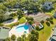 Aerial view displays community amenities like a pool, tennis court, and sand volleyball surrounded by lush landscaping at 6178 Westgate Dr # 304, Orlando, FL 32835