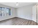 Sunlit bedroom with hardwood floors and a large window with blinds at 6178 Westgate Dr # 304, Orlando, FL 32835