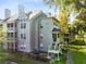 View of the condo community with exterior stairs, balcony and green surroundings at 6178 Westgate Dr # 304, Orlando, FL 32835
