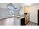 Open concept kitchen with peninsula, stylish backsplash, and modern lighting at 6178 Westgate Dr # 304, Orlando, FL 32835