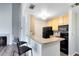 Galley kitchen showcasing black appliances and a tiled backsplash at 6178 Westgate Dr # 304, Orlando, FL 32835
