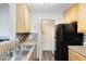 Cozy kitchen featuring stainless steel sink, tile backsplash, and laundry closet at 6178 Westgate Dr # 304, Orlando, FL 32835