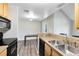 Spacious kitchen with stainless steel sink, wood cabinets, and appliances at 6178 Westgate Dr # 304, Orlando, FL 32835