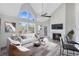 Staged living room with modern furniture, a fireplace, and views from the windows at 6178 Westgate Dr # 304, Orlando, FL 32835