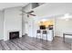 Open-concept living room with a fireplace and a view into the kitchen at 6178 Westgate Dr # 304, Orlando, FL 32835