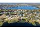 Picturesque aerial view of the property, nestled among lush trees and backing onto a serene lake at 641 Lake Catherine Dr, Maitland, FL 32751