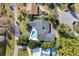 Aerial view of property with a backyard pool and deck, surrounded by lush greenery and mature trees at 641 Lake Catherine Dr, Maitland, FL 32751