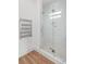 A modern bathroom with glass shower door and heated towel rack at 641 Lake Catherine Dr, Maitland, FL 32751