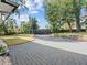 Long paved driveway leading to a private residence, surrounded by a beautiful green lawn with mature trees at 641 Lake Catherine Dr, Maitland, FL 32751