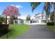 Elegant modern home with a circular driveway and lush green lawn at 641 Lake Catherine Dr, Maitland, FL 32751