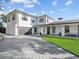 Elegant home showcasing a brick driveway, attached garage, manicured lawn, and covered porch at 641 Lake Catherine Dr, Maitland, FL 32751