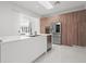 Contemporary kitchen featuring white cabinets, stainless steel appliances, and a sleek, modern design at 641 Lake Catherine Dr, Maitland, FL 32751