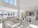 Spacious, modern living room with comfortable white sofas and serene lake views at 641 Lake Catherine Dr, Maitland, FL 32751