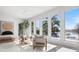 Sunlit living room with floor-to-ceiling windows offering picturesque lake and pool views at 641 Lake Catherine Dr, Maitland, FL 32751