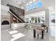 Bright, open living room with soaring ceilings, modern staircase, and elegant decor at 641 Lake Catherine Dr, Maitland, FL 32751