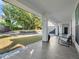 Welcoming covered porch area with outdoor seating, lush green grass, white columns, and meticulous landscaping at 641 Lake Catherine Dr, Maitland, FL 32751