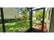 Enclosed lanai with a view of the private backyard featuring lush greenery at 658 Olympic Dr, Ocoee, FL 34761