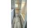 Bathroom with wood look flooring, light blue vanity, neutral walls, and shower tub combo at 658 Olympic Dr, Ocoee, FL 34761