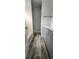 Bathroom with wood look flooring, tub shower combo, light blue vanity, and neutral walls at 658 Olympic Dr, Ocoee, FL 34761