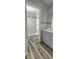 Modern bathroom with a vanity, updated shower featuring a marble-look tile surround, and wood-look flooring at 658 Olympic Dr, Ocoee, FL 34761