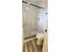 Bathroom showcasing a new shower featuring modern fixtures and elegant marble-look tiles at 658 Olympic Dr, Ocoee, FL 34761
