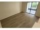 Bedroom featuring wood floors and sliding glass door access to the lanai at 658 Olympic Dr, Ocoee, FL 34761