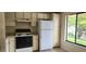 Well-lit kitchen with neutral cabinets and appliances, creating a functional cooking space at 658 Olympic Dr, Ocoee, FL 34761