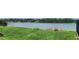 Serene lake view from grassy backyard creating a tranquil living environment at 658 Olympic Dr, Ocoee, FL 34761