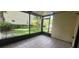 Enclosed lanai featuring neutral tile flooring and backyard views at 658 Olympic Dr, Ocoee, FL 34761