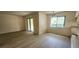 Spacious living area with sliding glass doors and modern flooring, perfect for relaxation and entertainment at 658 Olympic Dr, Ocoee, FL 34761
