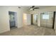 Spacious main bedroom with a fan, closet with mirror doors and adjacent bathroom at 658 Olympic Dr, Ocoee, FL 34761
