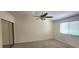 Main bedroom features modern windows, a ceiling fan, and a closet with mirrored doors at 658 Olympic Dr, Ocoee, FL 34761